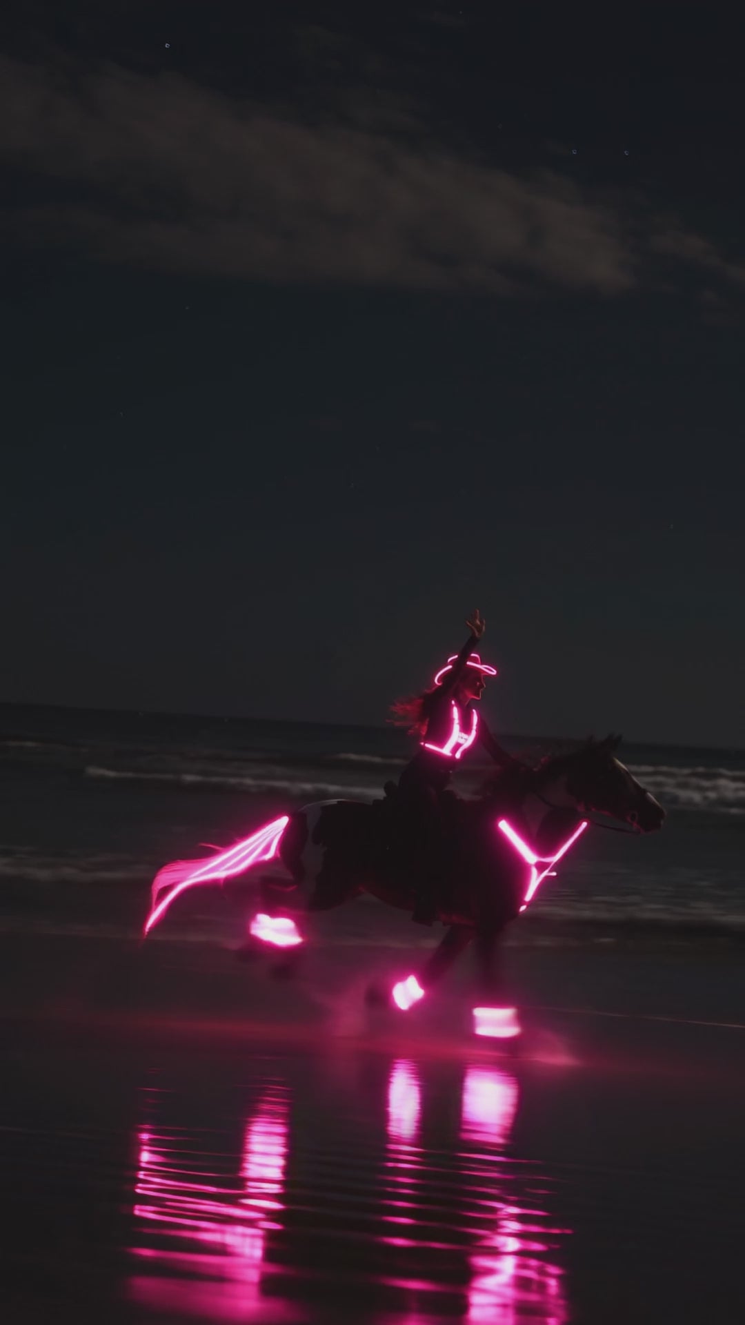 Rider and horse glowing on a trail after dark